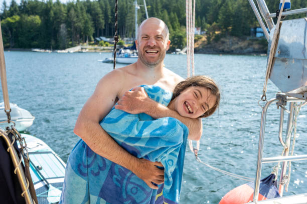 istock Father and daughter cuddles on sailboat 2162013784