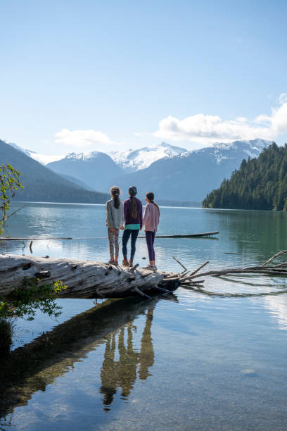 istock Family balances on log 2162013819