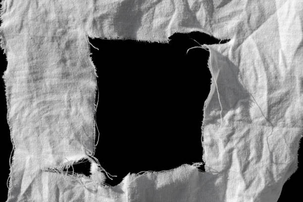 istock old torn white rag with black holes 2162020151