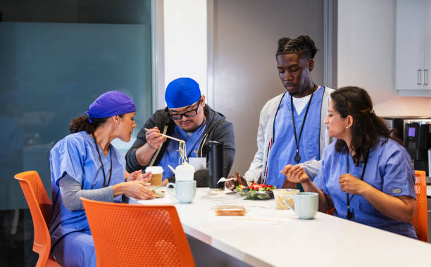 istock Multiracial healthcare workers having lunch in breakroom 2162023716