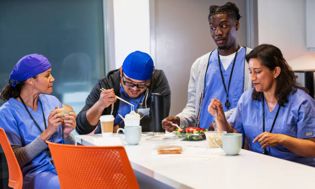 istock Multiracial healthcare workers having lunch in breakroom 2162023719