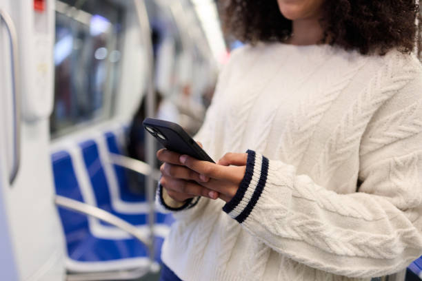 istock Close-up young woman using smartphone during metro ride 2162030180