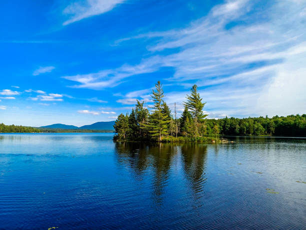 istock Big lake with mountains and trees reflected in the water 2162031805