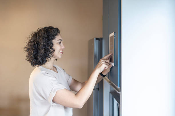 istock Latina woman controlling smart home 2162033196