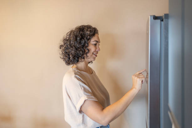 istock Latina woman controlling smart home 2162033200