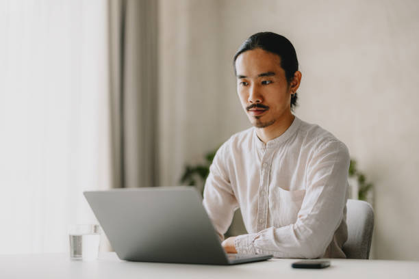 istock Focused Man Working on Laptop in Modern Office 2162033353