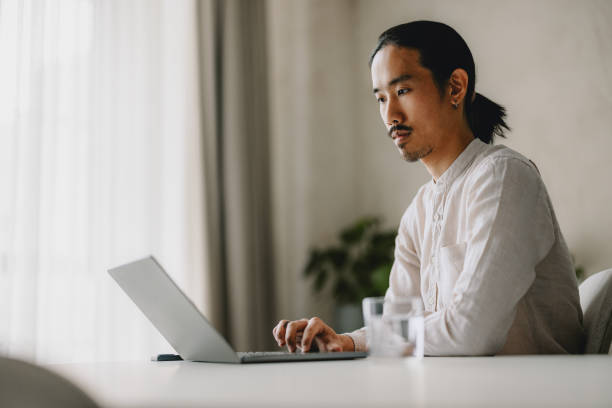 istock Young Professional Man Working On Laptop In Modern Office 2162033361