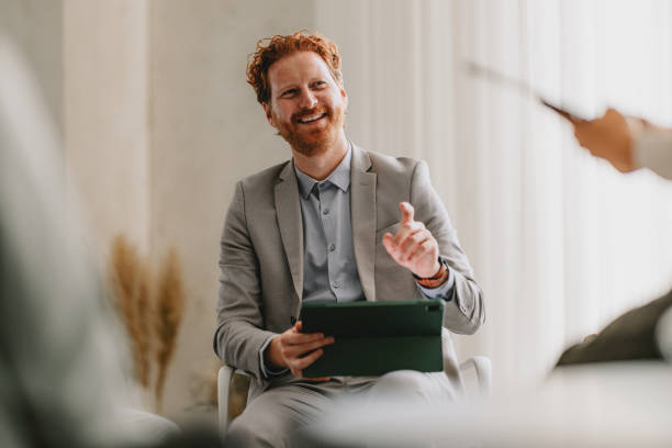 istock Confident Businessman Leading Office Group Meeting with Tablet 2162033397