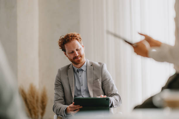 istock Business Team Discussing Ideas in Bright Beige Office 2162033398
