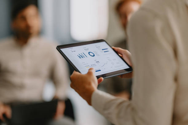 istock Group Business Meeting with Digital Tablet and Graphs in Office 2162033408