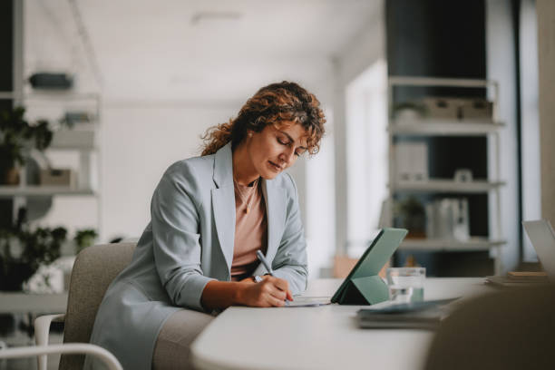 istock Focused Businesswoman Working in a Bright Modern Office 2162033420