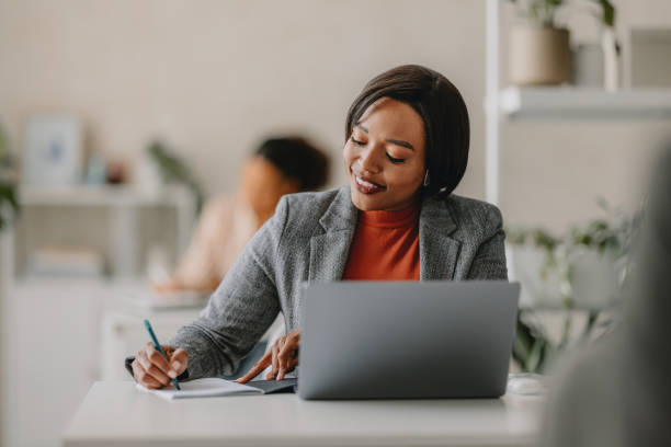 Businesswoman Working in Bright Modern Beige Office Setting