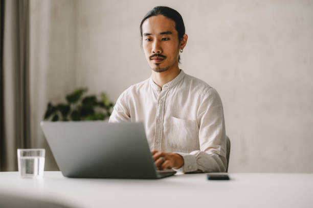 istock Focused Businessman Working on Laptop in Bright Modern Office 2162033495