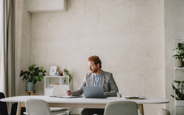 Businessman Working in a Modern Bright Beige Office