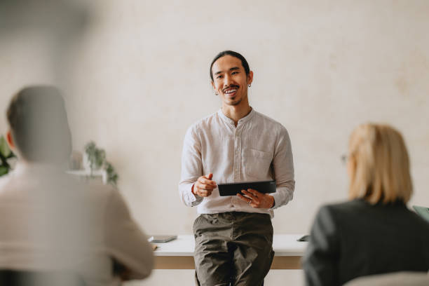 istock Businessman Presenting To Colleagues In Bright Beige Office 2162033605