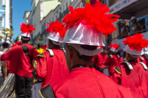 Salvador, Bahia, Brazil - June 02, 2024: Musicians in uniform are seen playing musical instruments during the independence celebration in Bahia. City of Salvador.