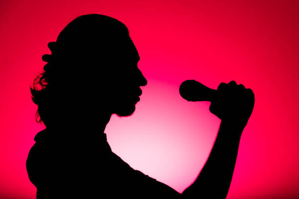 Silhouette of male singer with microphone