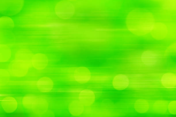 Defocused background in green tones. Beautiful bokeh lights with blurred motion effect. Space for copy.