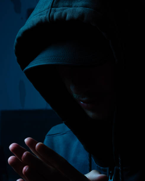 istock Mysterious young man in gray coat hiding his face. Studio portrait. 2162037269