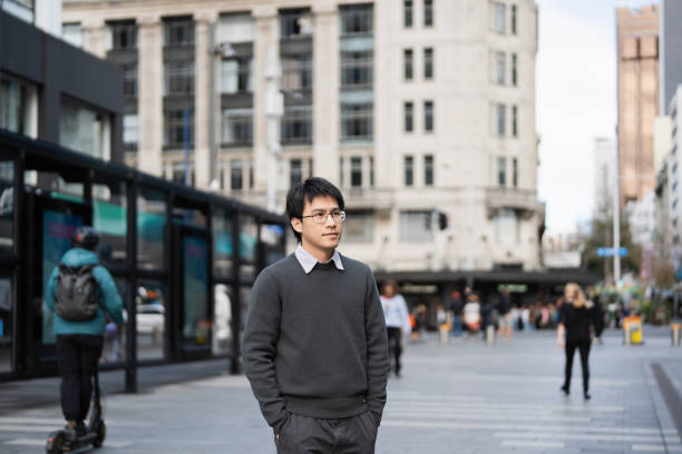 istock Asian youth walking through a modern urban environment 2162041488