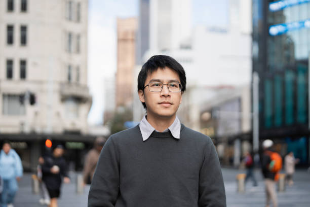 istock Close-up of an Asian man walking on a crowded intersection 2162041490