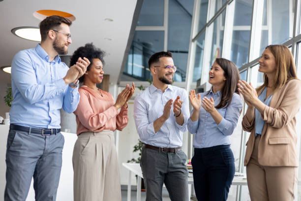 istock Team of professionals clapping together 2162042859