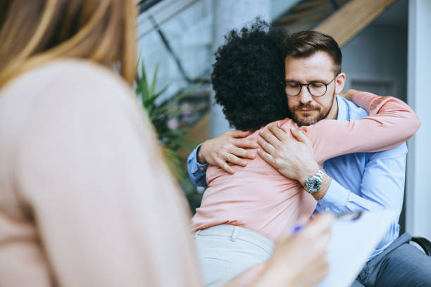 Man hugging woman in emotional office scene