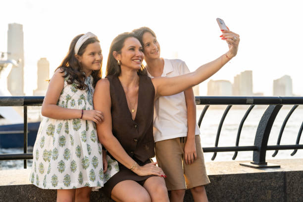 istock Mother taking a selfie with her two children at sunset 2162051919
