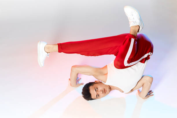Group of young adults breakdancing in the streets.