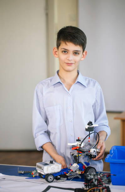 istock Little boy in robotics school makes robot 2162052930