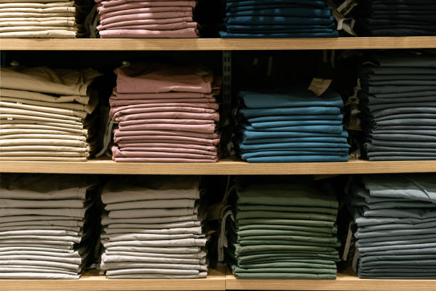 istock Stack of cotton colorful clothes on table in cloth store. 2162053008