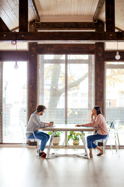 istock Couple sharing ideas, sitting opposite near big window. 2162053152