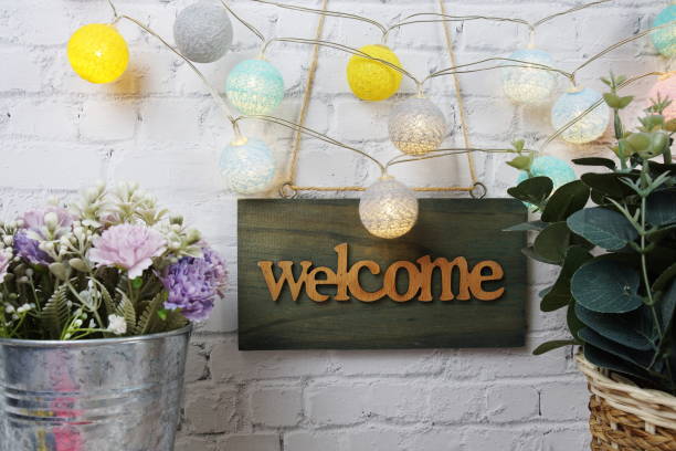 istock Welcome sign Hanging on grunge cement wall background 2162053195