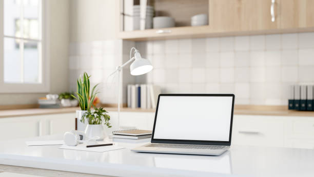 istock A laptop computer mockups on a modern white kitchen island in a minimalist white kitchen. 2162054661