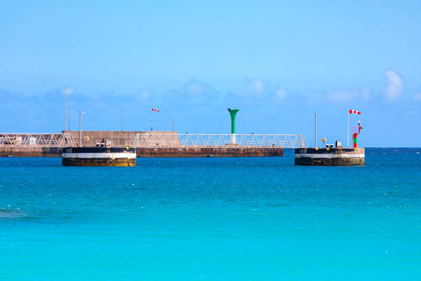 Pier with lighthouse in the ocean. Pier in turquoise water