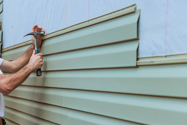 istock Contractor installing vinyl siding plastic panels on facade wall of a new home 2162056690