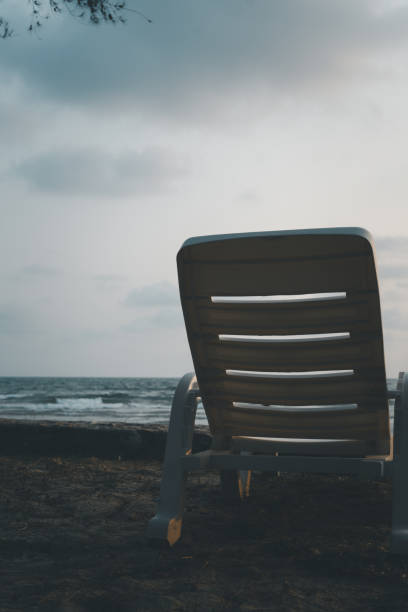 istock Empty white beach chair along the beach 2162056750