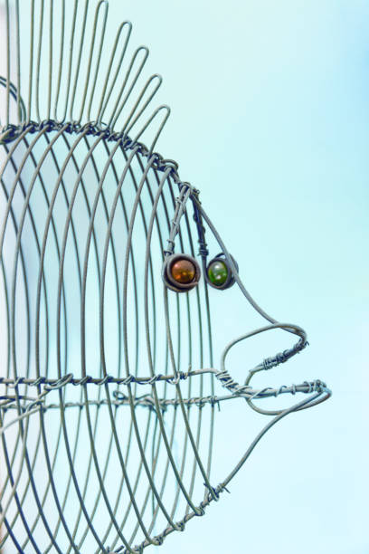 istock wire african art, fish doodle on blue background 2162057227