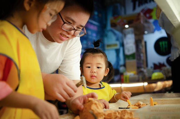 Mom guides children in archaeological toys