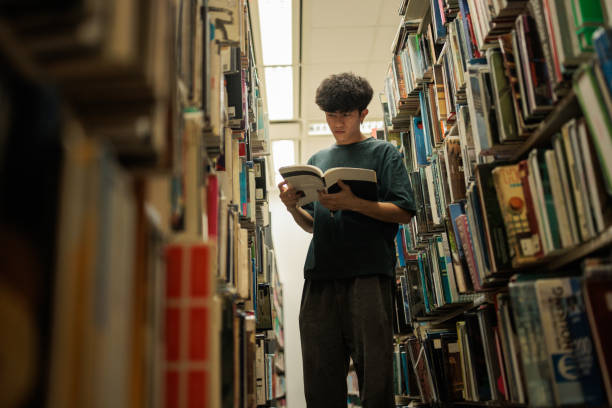 istock Male student at university library 2162057994