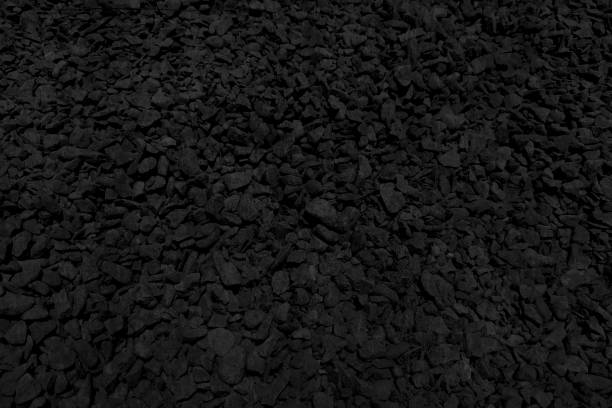 istock Very dark Grey or gray black coloured pebbles or gravel or crushed stones horizontal vector illustration with all over pattern  of small rocks or stones making a rough rustic pebbled backdrop 2162061233