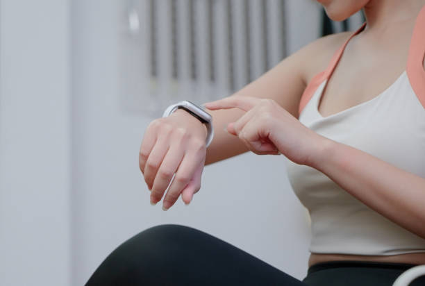 istock Asian woman using smart watch in gym 2162063203