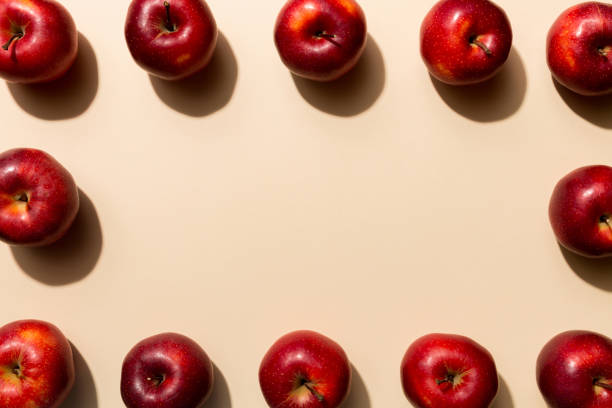 istock Many red apples on colored background, top view. Autumn pattern with fresh apple above view 2162067114