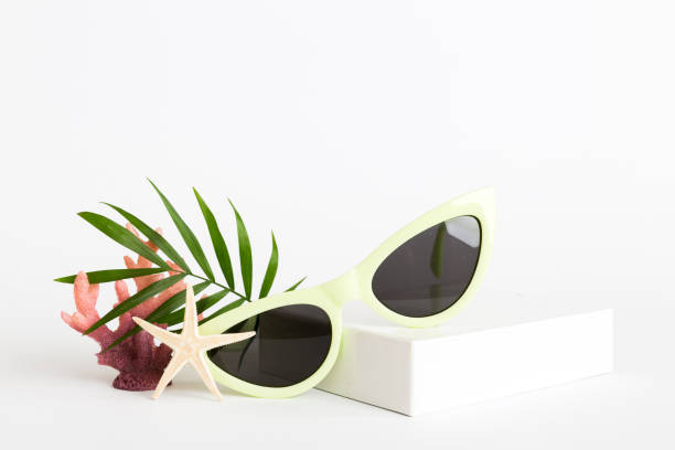 istock sunglasses with seashell lying on table background. Sunglasses on summer background. Top view flat lay with copy space for text 2162067166