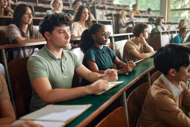 istock Group of college students attending a class in amphitheater. 2162068110