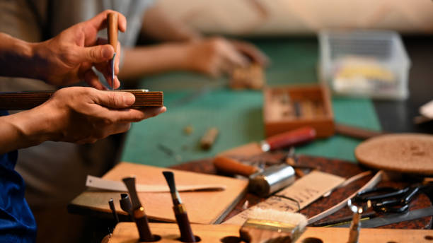 istock Close up shot of experienced craftsman in leather belt making process at his workshop 2162068458