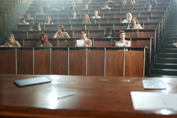 istock Large group of diverse university students having a class at lecture hall. 2162068638