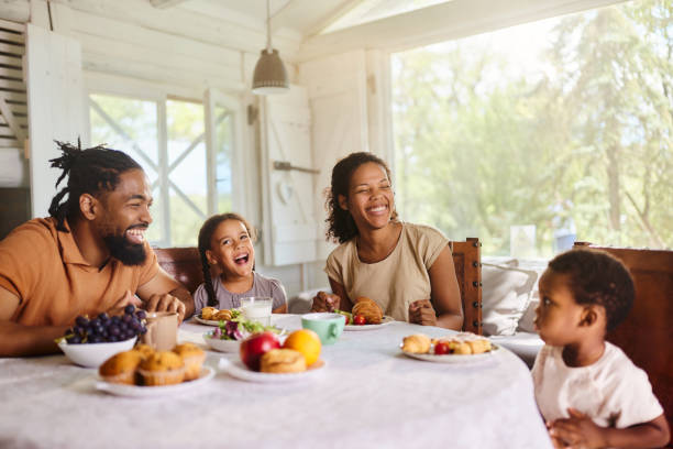 istock Happy black family talking during breakfast at dining table. 2162068754