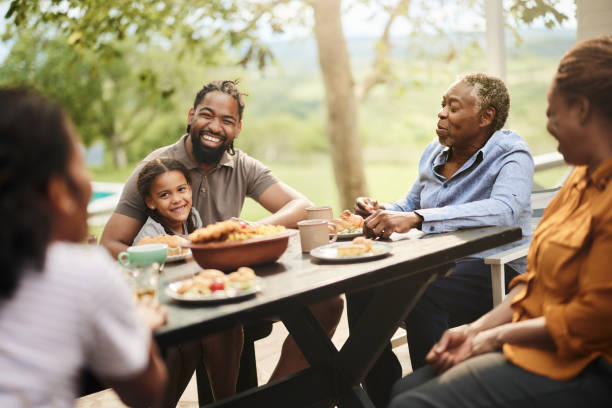 istock Happy black extended family talking while having a meal at patio. 2162069106