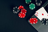 red-and-black-casino-chips-on-a-table-with-a-laptop-and-playing-cards.jpg?b=1&s=170x170&k=20&c=MJShjXPEE39_JKqoAGBi6t1HMKxSE4kAsCJjtUm72WA=